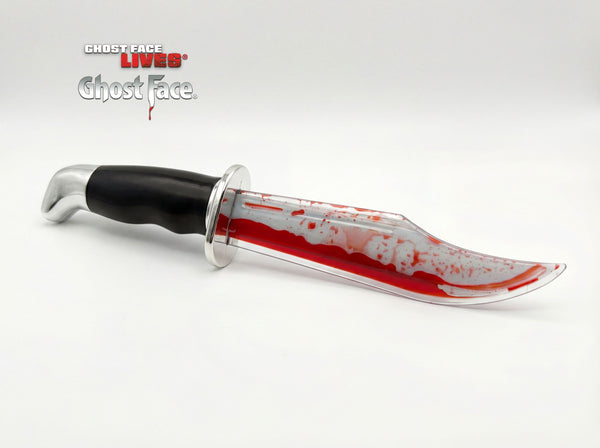 Scream Deluxe Ghost Face Bleeding Knife Costume Prop Weapon featuring a clear plastic blade filled with red liquid that shifts and pools for a dynamic “bleeding” effect, paired with a textured black handle and silver‑tone guard for a classic slasher look. The moving red fluid creates a bold, dripping‑blood illusion, while the contrast between the sleek handle and vivid blade gives it a cinematic, eye‑catching finish
