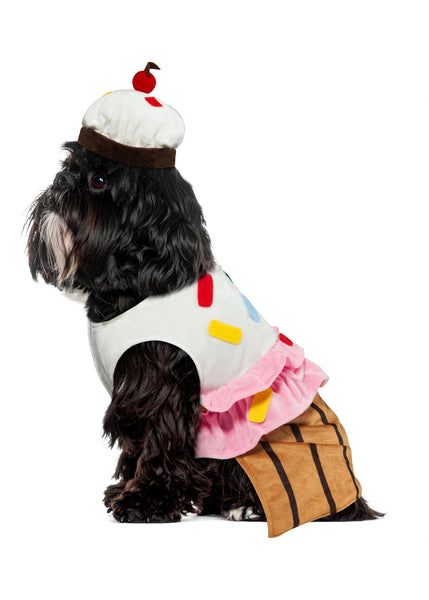 Side of Shih Tzu wearing the Pets Cute Cupcake Costume featuring a sweet, dessert‑inspired two‑piece outfit with a soft plush body designed to resemble a cupcake base in rich golden‑brown tones with vertical liner striping; topped with a layered “frosting” section made from fluffy white and pink fabric, decorated with colorful sprinkle accents in red, yellow, blue, and green. The look is completed with a matching cupcake headpiece topped with a red pom‑pom cherry detail, adding the perfect finishing touch 