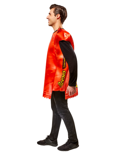 Side view of a Man in Adults Reese's Peanut Butter Cup Candy Costume featuring a bold, oversized tunic designed to resemble a classic Reese’s wrapper, printed in vibrant orange with large yellow “Reese’s” lettering and a detailed image of a sliced peanut butter cup at the top; styled with crimped “wrapper” edges at the neckline and hem for a realistic candy‑bar effect. The lightweight, sleeveless design slips easily over clothing, creating a full‑body candy package silhouette that’s instantly recognizable 