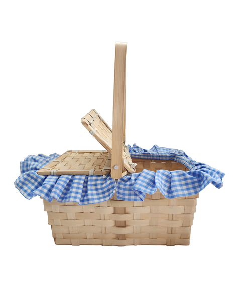 A woven natural wood picnic basket with a blue and white gingham checkered ruffled trim