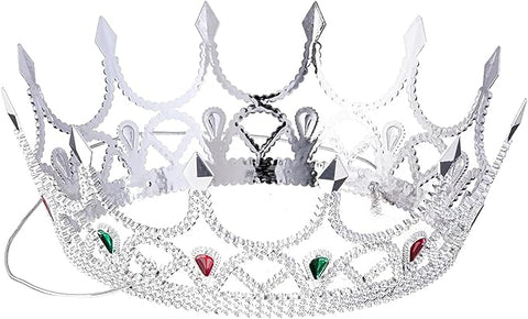 Silver Royal Queen Crown Costume Accessory features an ornate silver‑tone crown with an intricate openwork design, pointed arches, and delicate scroll detailing throughout; embellished with faceted clear rhinestones and accent gems in red and green set along the front, designed with a lightweight metal look and an elastic strap
