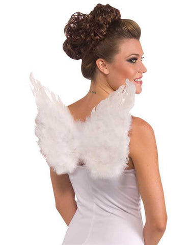 Woman modeling the Small Club Feather Angel Wings Costume Accessory which features compact pair of layered white feather wings designed in a classic angel shape, with soft, fluffy feathers arranged to create a rounded, airy silhouette; finished with a plush feather trim along the top edge and elastic shoulder straps attached at the back, allowing the wings to sit neatly and visibly centered