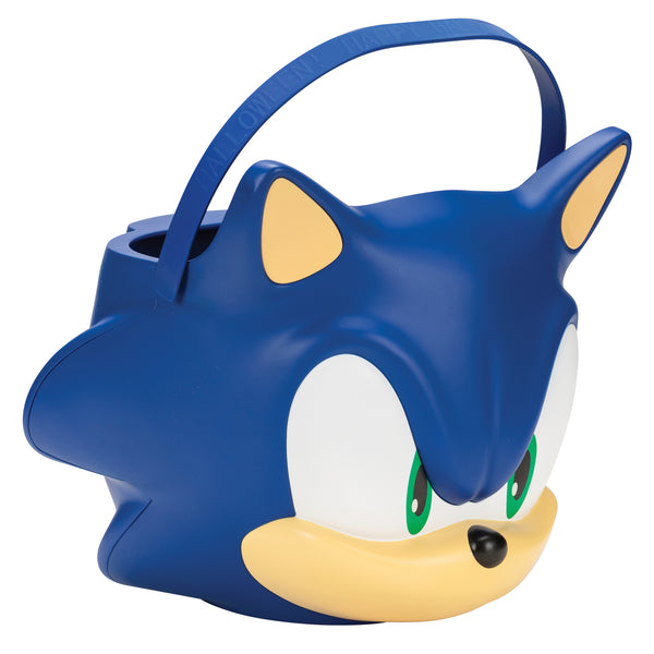 Side of Sonic the Hedgehog Jumbo Trick or Treat Pail Bucket
Features a large, mold plastic bucket designed in the shape of Sonic’s iconic face, complete with bright blue coloring, oversized white eye panels, green iris details, and a signature smirk. The design includes raised contouring for added dimension, along with a sturdy curved handle across the top for easy carrying. The bucket measures approximately 7.5 inches tall and just under 8 inches wide, offering a roomy interior for candy or small items