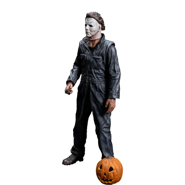 Halloween 1978 Michael Myers 8" Collector's Action Figure Collectible Toy in gray coveralls and white mask while holding a knife with jack-o-lantern accessory, left side view