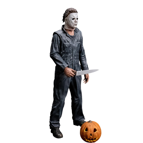 Halloween 1978 Michael Myers 8" Collector's Action Figure Collectible Toy in gray coveralls and white mask while holding a knife with jack-o-lantern accessory, side view