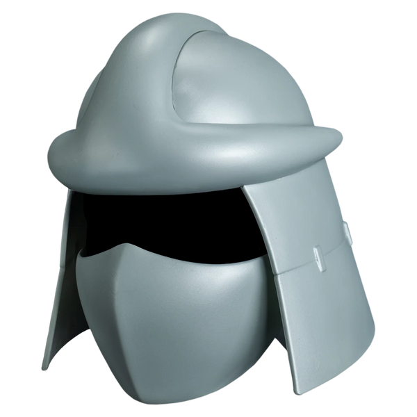 Teenage Mutant Ninja Turtles Shredder's Costume Helmet features injection‑molded sculpt with a sleek metallic silver finish, sharply angular contours, raised panel ridges, and Shredder’s signature bladed crest flaring upward and outward from the crown; includes narrow, aggressive eye slits and a smooth surface, left profile