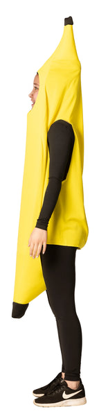 Side view of Teenager in the Teens Banana Costume Featuring a bright yellow banana-shaped tunic with a smooth fabric finish and a curved silhouette that tapers at the top and bottom with dark brown tip accents. The costume includes a front oval face opening and wide arm openings