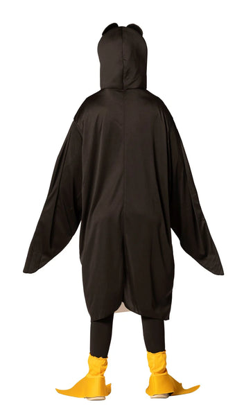 Back view of Teenager in the Teens Penguin Costume Featuring a black and white penguin tunic made from lightweight fabric, designed with a white front panel and black back and sides that create a classic penguin color pattern. The costume includes an attached hood with a yellow beak and large stylized eyes, along with a red bow tie at the neckline. The long wing-like sleeves have openings that allow hands to come through, and matching yellow flipper-style shoe covers complete the look.