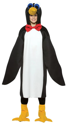 Teenager in the Teens Penguin Costume Featuring a black and white penguin tunic made from lightweight fabric, designed with a white front panel and black back and sides that create a classic penguin color pattern. The costume includes an attached hood with a yellow beak and large stylized eyes, along with a red bow tie at the neckline. The long wing-like sleeves have openings that allow hands to come through, and matching yellow flipper-style shoe covers complete the look.