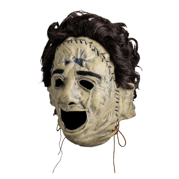 The Texas Chainsaw Massacre Killing Mask Vinyl Costume Mask vinyl Leatherface with skin stitched details and attached hair, left profile view