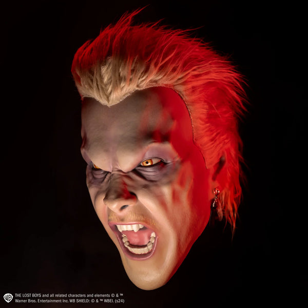 The Lost Boys David Deluxe Injection Costume Mask with  bright orange eyes, hissing expression, fang showing teeth, and attached hair and earring, cinematic view with black background and red glow