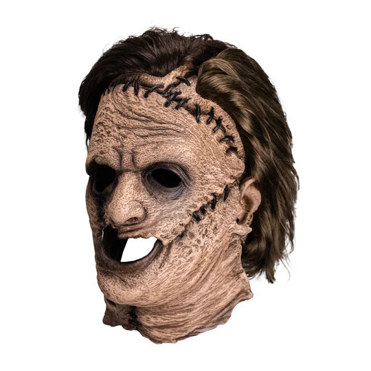 The Texas Chainsaw Massacre Leatherface Costume Mask of a full over the head latex mask of Leatherface's gruesome scars and stitches, weathered looking skin, and attached hair, left side profile