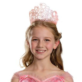Girl in the Wizard of Oz Wicked Glinda the Good Witch Tiara Costume Accessory Featuring a light pink plastic tiara designed with interconnected swirling circular patterns and raised starburst accents, this accessory includes embedded clear gem details placed throughout the design for added decoration. The openwork structure creates a layered look, with curved shapes and cutout sections forming a rounded crown silhouette.