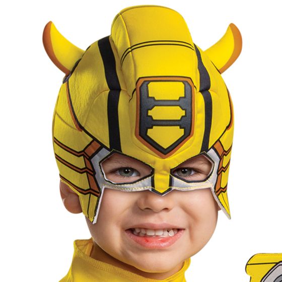 Head close up of Boy in Toddlers Transformers Bumblebee Muscle Costume
Featuring a full-length jumpsuit designed in bright yellow with black and gray mechanical-style armor printing, this costume includes padded muscle detailing in the torso and arms to create a sculpted look. The design incorporates printed panel sections across the chest, shoulders, and legs with metallic-inspired textures, along with attached boot covers for a complete appearance. The set also includes a soft character headpiece.