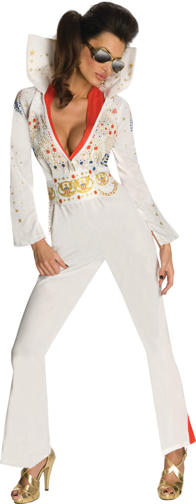 Woman posing in the Womens Deluxe Elvis Presley Aloha from Hawaii Costume which includes a white one‑piece jumpsuit, designed with a dramatic deep V neckline trimmed with the red scarf; embellished across the chest and sleeves with ornate gold, red, and blue jewel‑style accents and star motifs. The jumpsuit is finished with long fitted sleeves that flare slightly at the cuffs, a wide gold decorative belt motif, and structured pant legs that fall into bell‑bottom shape